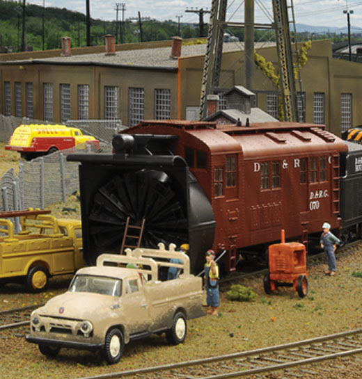 Weathered vehicle scene featuring a rotary snow plow